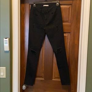 Black jeggings with rips in knees